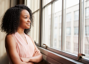 woman looking out window smiling