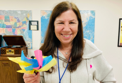 woman holds origami flower