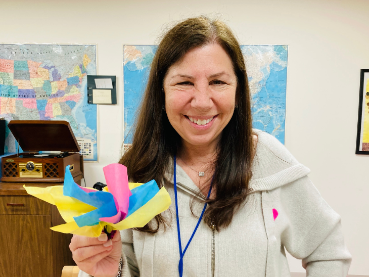 woman holds origami flower