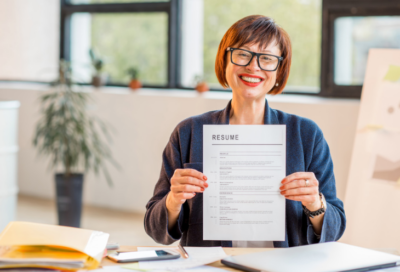 woman proudly shows off resume