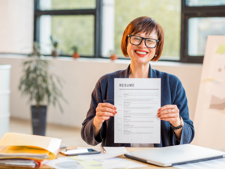woman proudly shows off resume