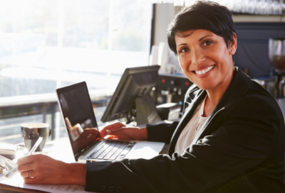 woman with laptop takes notes