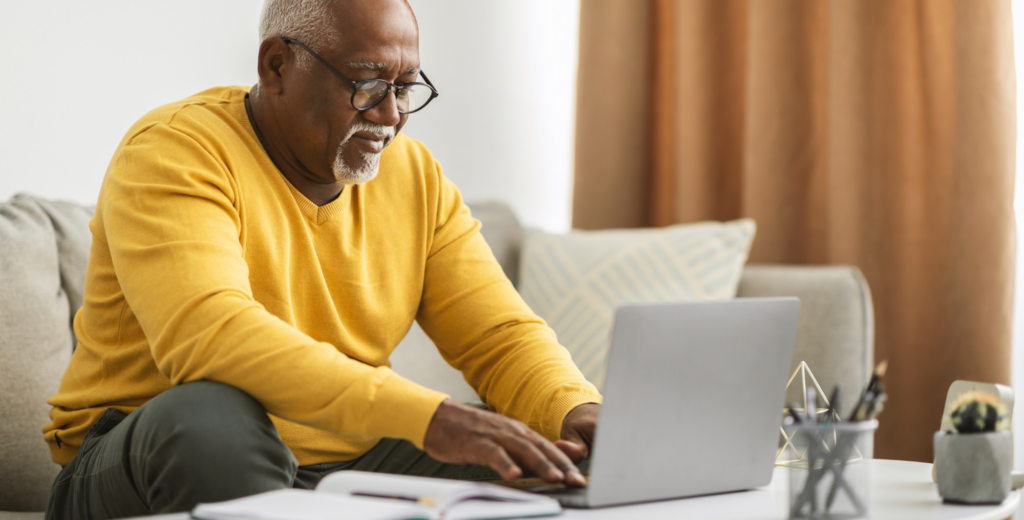 Man using laptop on coffee table