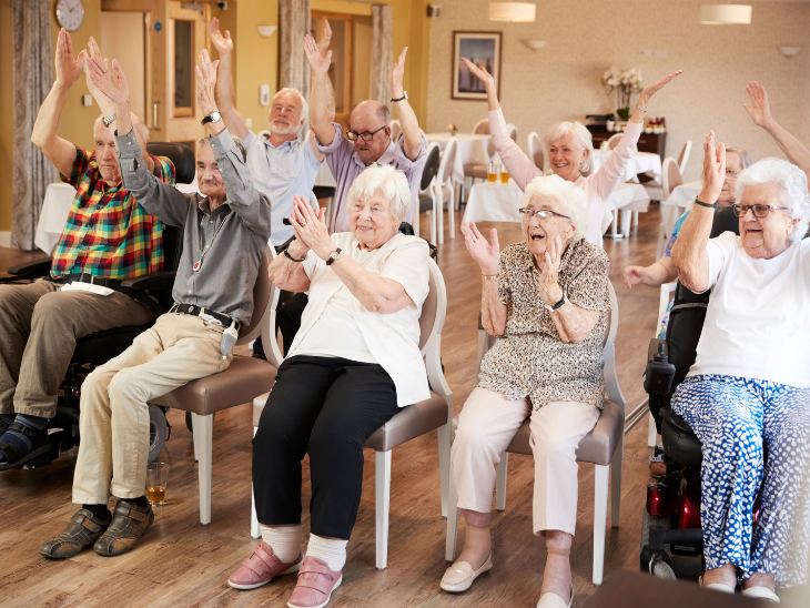 group of older adults doing seated exercises